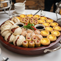 Assorted dim sum catering platter with dumplings and buns